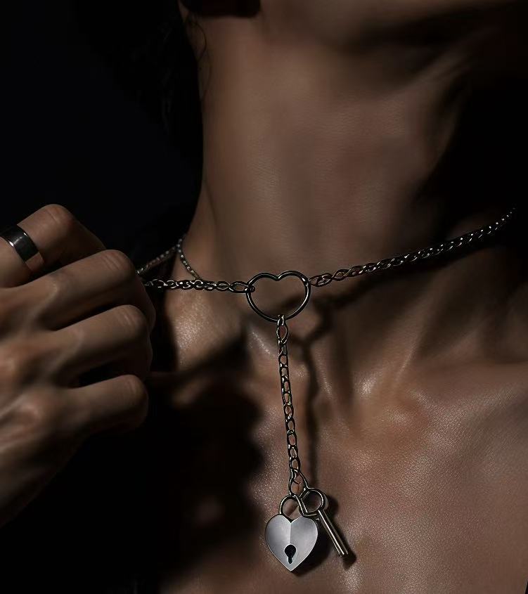 Close up men's silver heart lock necklace with key pendant, adjustable chain jewelry for couples