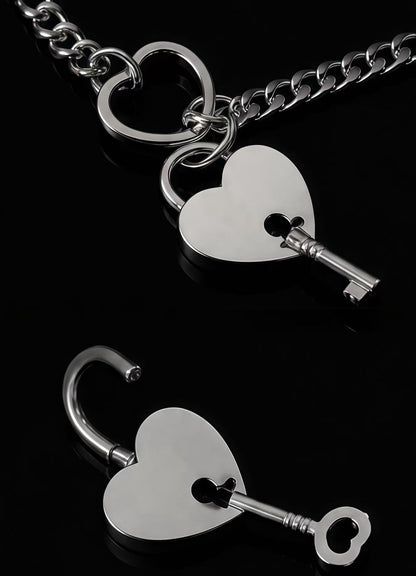 Close up silver heart lock necklace with matching key pendant, detailed metal jewelry craftsmanship